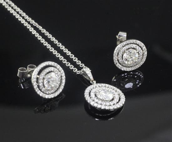 A white gold and diamond set target pendant on a platinum chain and a pair of similar 18ct white gold earrings,